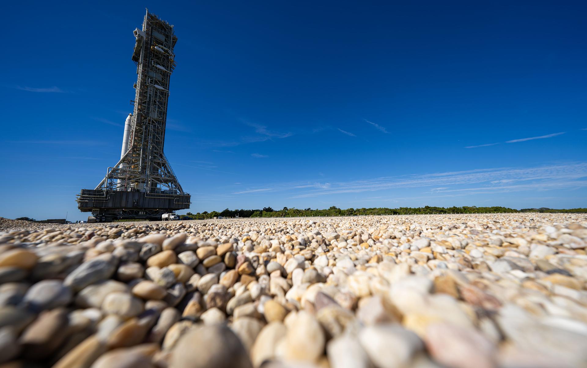 This image shows NASA’s SLS (Space Launch System) and Orion spacecraft rolling out of the Vehicle Assembly Building at NASA’s Kennedy Space Center. NASA's massive Crawler-Transporter, upgraded for the Artemis program, carries the powerful SLS rocket and Orion spacecraft on the Mobile Launcher from the Vehicle Assembly Building to Launch Pad 39B at Kennedy Space Center   in preparation for the Artemis II mission. 